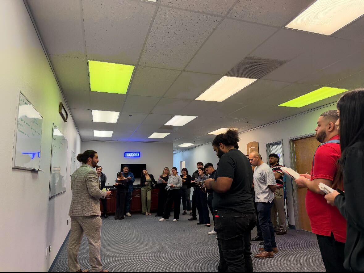 Palm City Management team training session with leader presenting at whiteboard